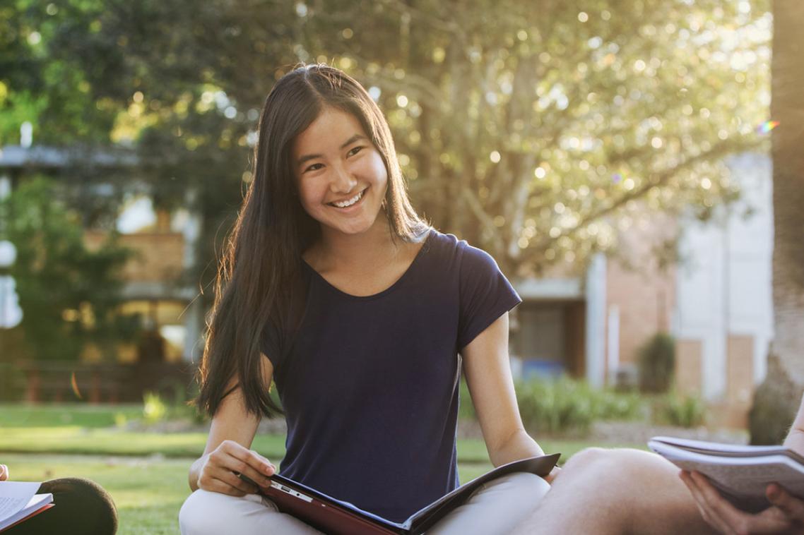 High school student reading a book